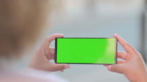 Close Up of Young African Woman Holding Phone with Green Screen