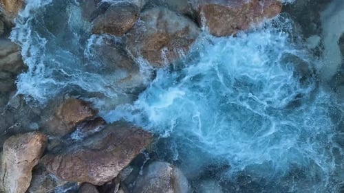 Aerial Drone Top Down View at Strong Streams of Cold Clean Water is Flowing Over Stones