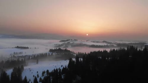 Aerial Mountain Sunset Over Winter Landscape