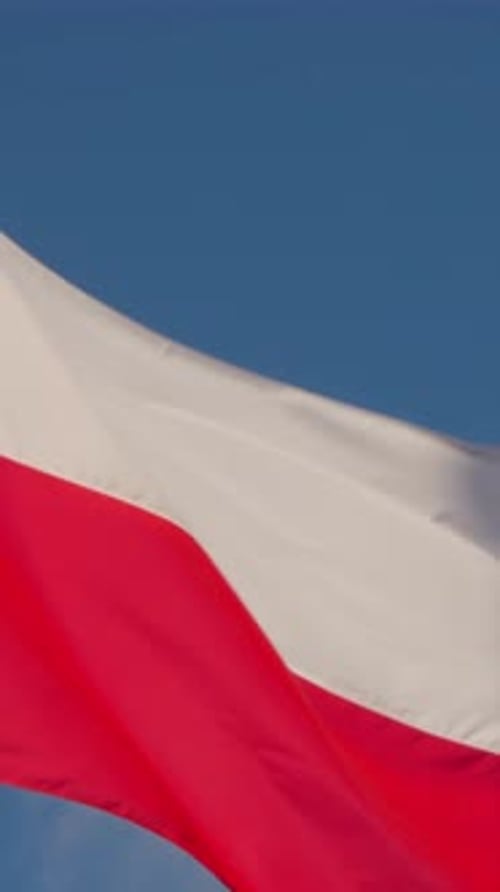 Polish Flag Waving Against a Blue Sky