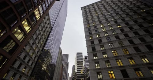 Modern Corporate Buildings Panning Up at Dusk with Lit Windows