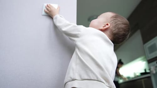 Infant Reaches for Light Switch at Home