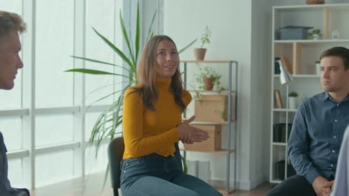 Woman Leading Group Discussion in Bright Office