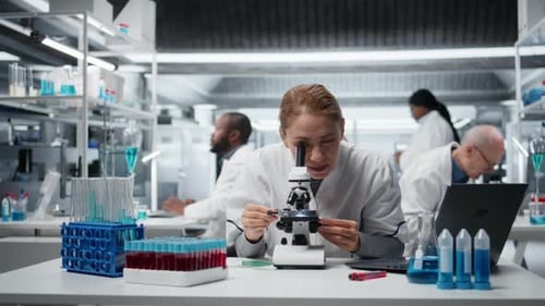 Scientist Using Microscope in Modern Research Laboratory