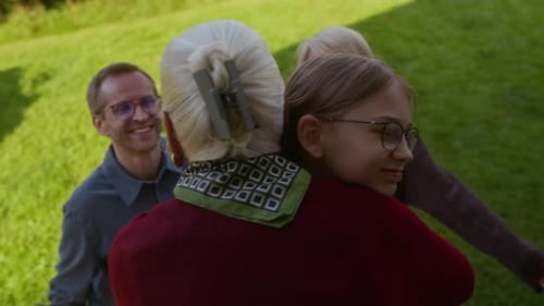 Family hug in garden with child, adults, senior