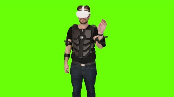 Man in white VR oculus vr virtual headset pointing and swiping with ...
