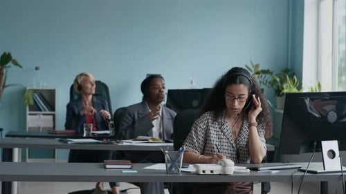 Young Intercultural Operators Taking Notes and Talking to Online Clients
