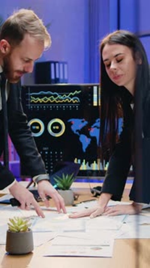 Team Collaborate Over Data Reports in Modern Office