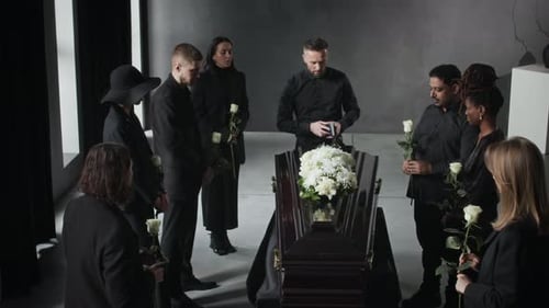 Mourners in Black, Each Holding White Rose Attending Funeral