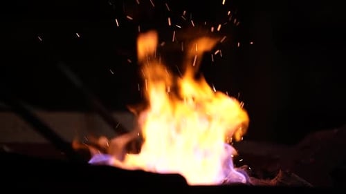 Close Up of Fire with Flying Sparks at Night