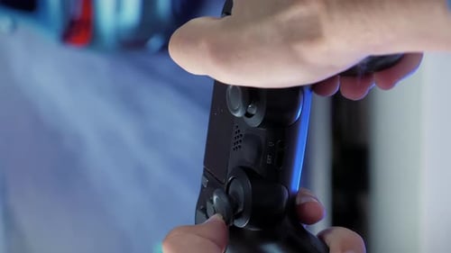 Hands Play Video Game on Black Controller