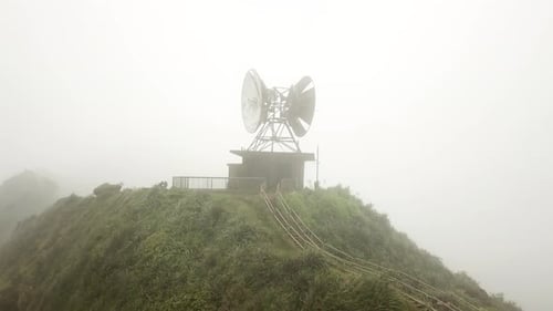 Radio Tower on top of Haiku Stairs (Stairway to Heaven) Trail in the Clouds on Oahu, Hawaii. Aerial.