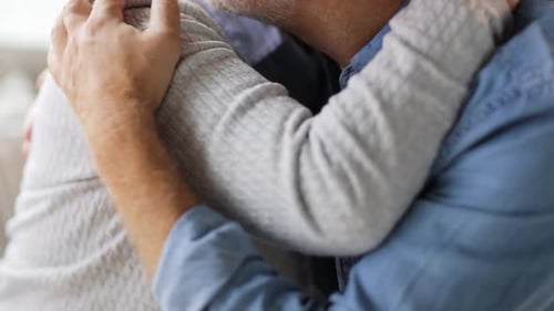 Senior Couple Embrace Affectionately Indoors