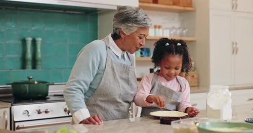 Child and Adult Baking a Pie in the Kitchen