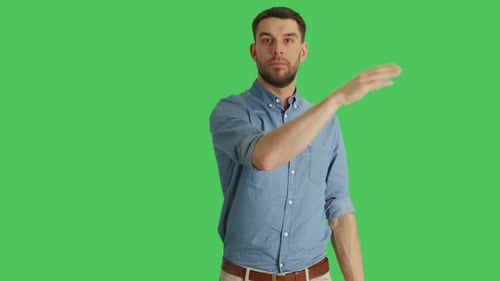 Medium Shot of a Casual Man Making Swiping and Touching Gestures while Standing on a Green Screen B