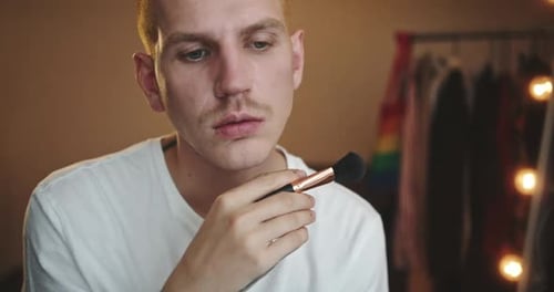 Person Applies Makeup With Brush, Close Up