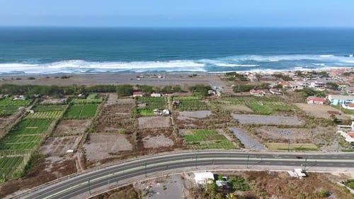 Aerial view of highway along the coastline. Brown sand beach with blue ocean water.4K drone footage.