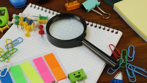 Office Supplies Magnifying Glass and Graph Paper Notebook