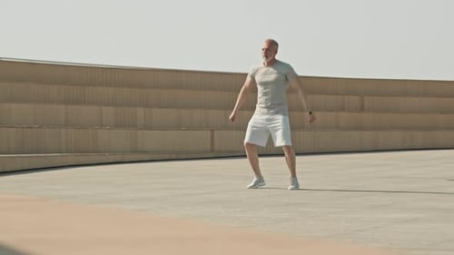 Active Senior Man Exercising Outdoors in Urban Setting