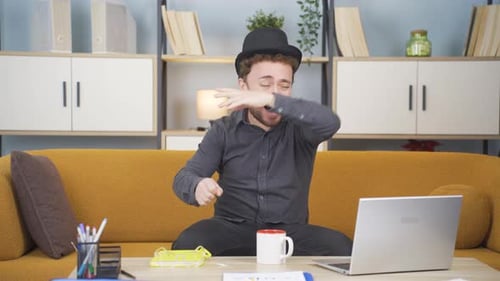 Charismatic man in hat dancing at home.