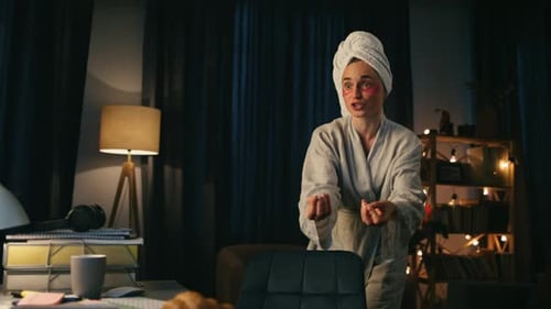 Woman in robe talking in home office