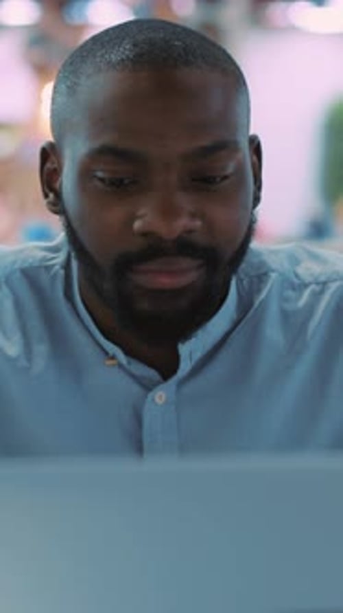 A Focused Professional Engaged in Work on a Laptop Within a Contemporary Modern Workspace