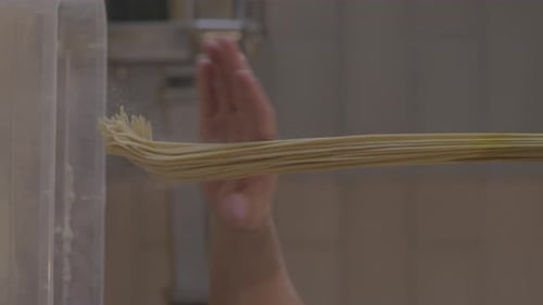 Italian Pasta Being Made on the Machine for Cutting Dough Fresh Handmade Pasta Machine Rolling Dough
