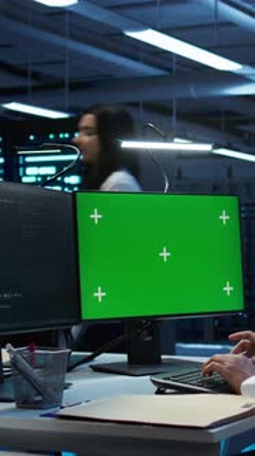 Vertical Video System Administrator Overseeing Data Center Using Green Screen Computer