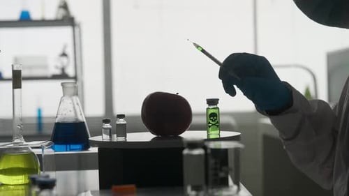 Dark Silhouette of a Male Scientist with a Syringe A Researcher Injects Pesticides and Nitrates Into