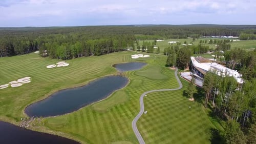 Experience the Scenic and Breathtaking Aerial View of a Luxurious Golf Course in Nature