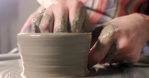 Hands Shaping Clay on a Potter's Wheel
