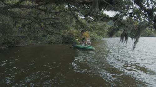 Woman and Child Kayaking on Quiet Lake