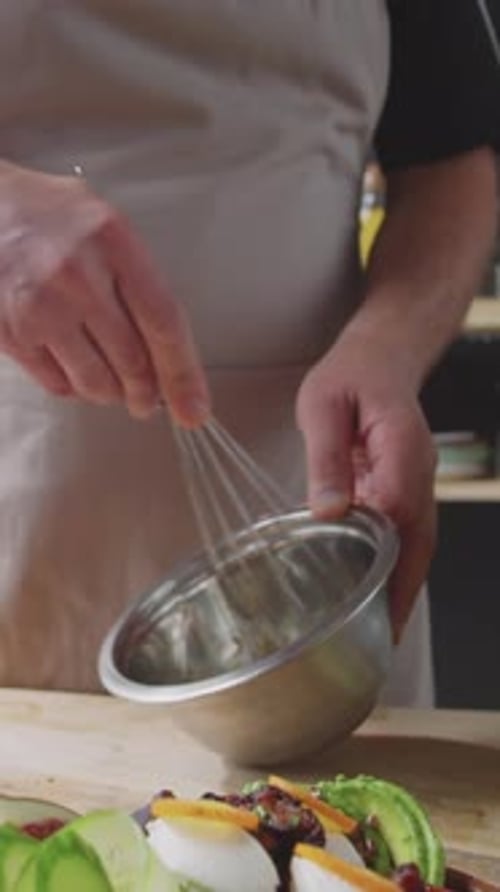 Chef Prepares a fresh salad in a home kitchen