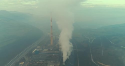 Abstract Aerial View of Coal Power Plant High Pipes with Black Smoke Moving Up Polluting Atmosphere