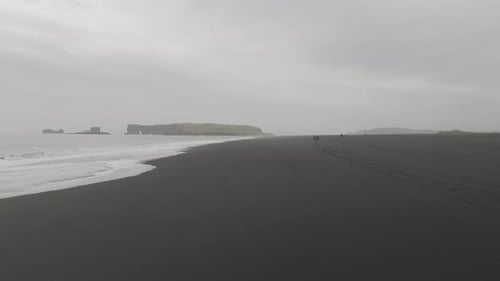 Aerial view of black sand beach in Iceland in winter.