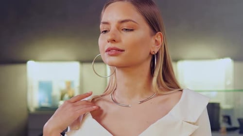 Graceful Girl with a Beautiful Face Posing in Jewelry Store with Accessories
