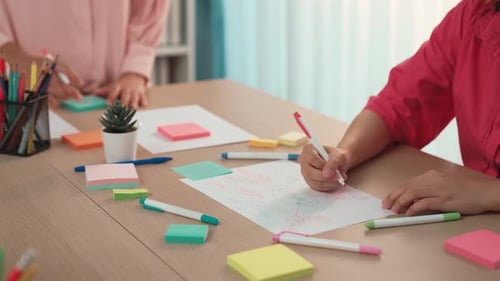 Creative Women Collaborating on Marketing Strategy at Table