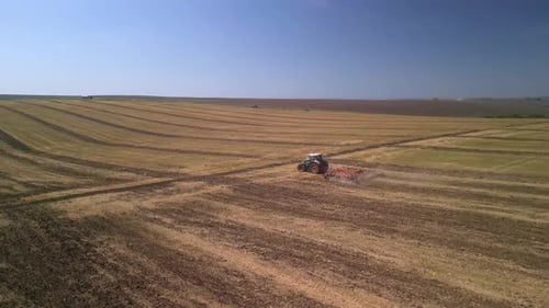 Tractor working on the field doing tillage with cultivator
