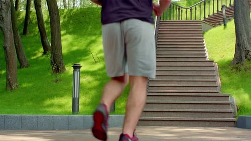 Athletic Man Running Up Stairs in a Park