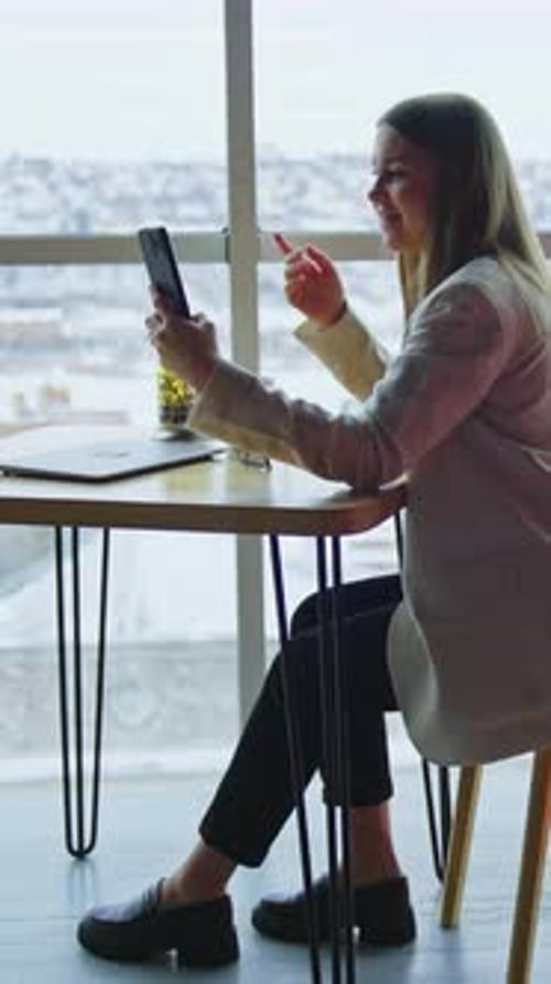 Pretty business woman working with smartphone. Lady office worker have a phone call. Vertical video