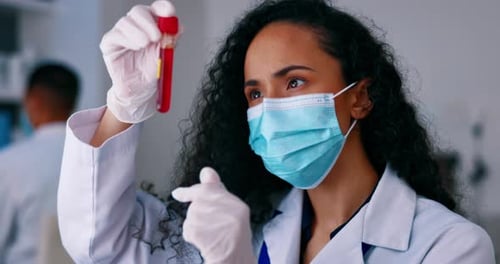 Medical Professional Examines Blood Sample in Lab