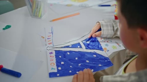 Child Decorates Eiffel Tower Drawing With Clay