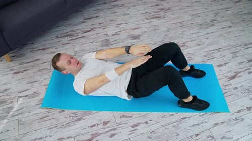 Strong male working out on quarantine. Healthy lifestyle man training his body in home.