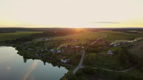 Enjoy the Serene Aerial View of a Beautiful and Tranquil Village Set at Sunset Time Stock Clip