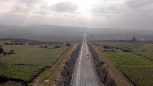 DRONE: AERIAL SHOT OF HIGHWAY WITH TRUCKS