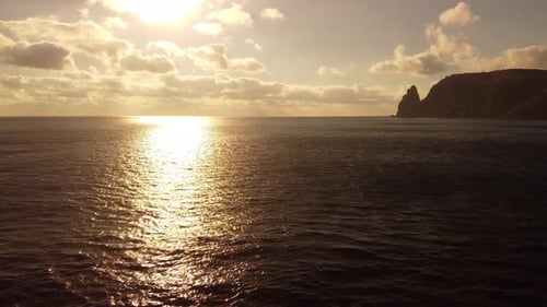 Aerial View on Sunset Over Calm Sea and Volcanic Rocky Shores