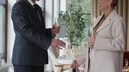 Business Colleagues Handshake With Champagne at Event