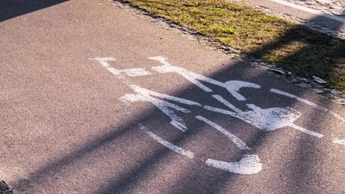 Zoom in Out Cyclist and Pedestrian Route Zone Sharing Sign on a Street Painted Street Asphalt