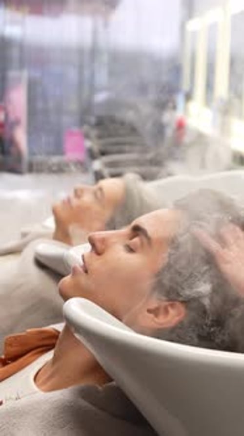 Women Get Hair Washed at Stylish Beauty Salon