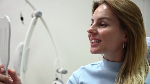 Young Beautiful Woman Smile After Dental Whitening Process Smile in Mirror Teeth Whitening with UF